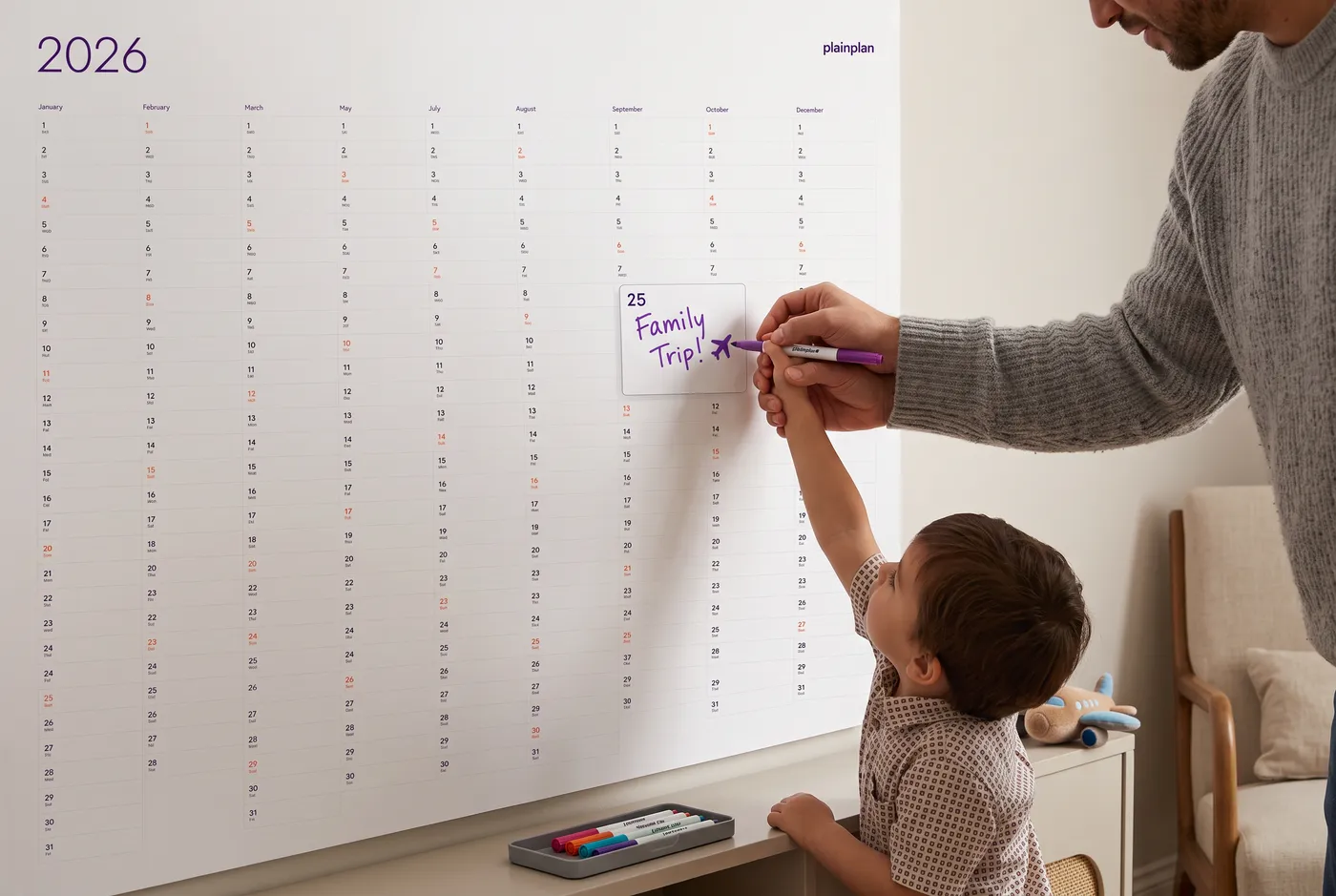 Family using a wall planner together