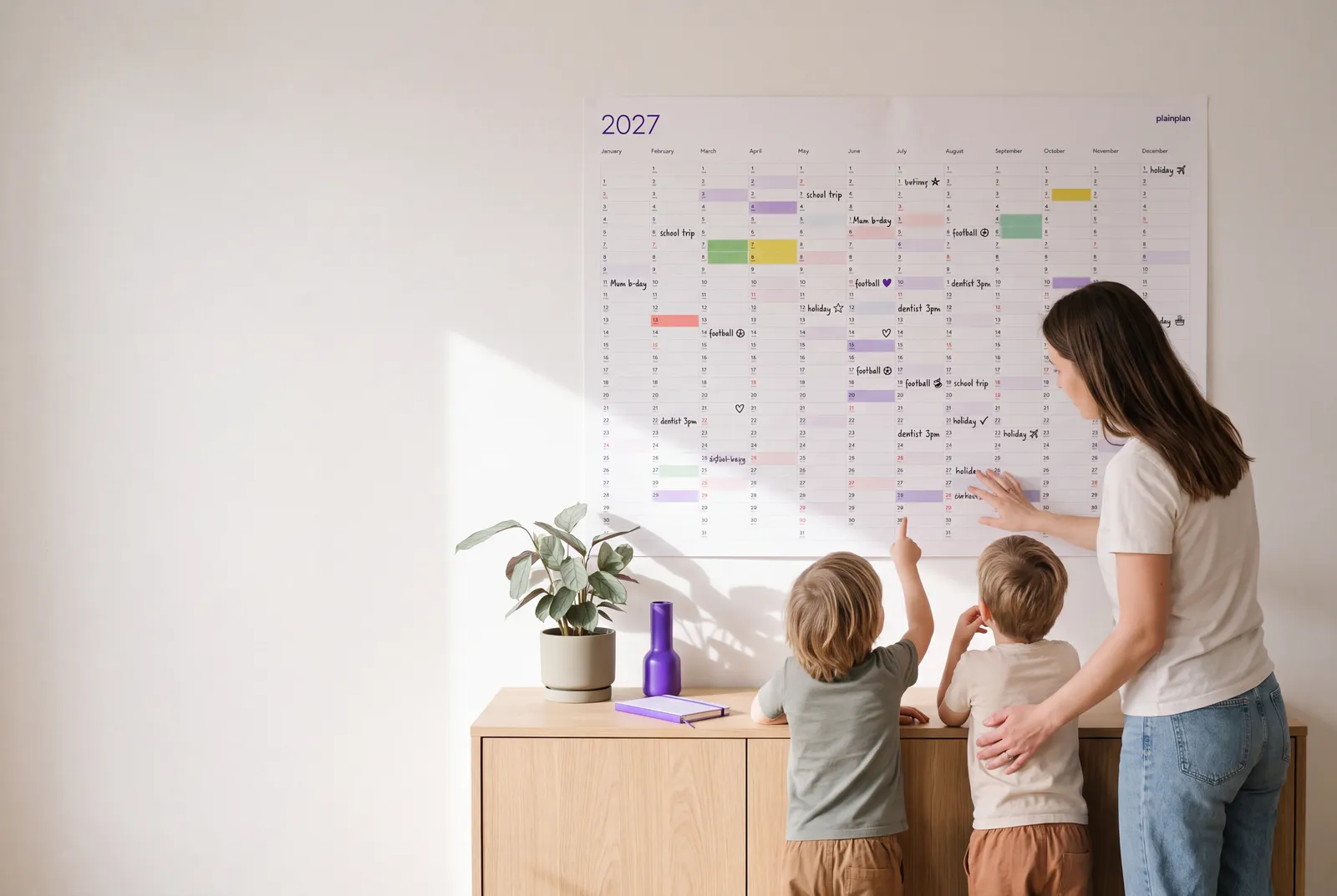 plainplan 2027 printable wall planner in a bright living room