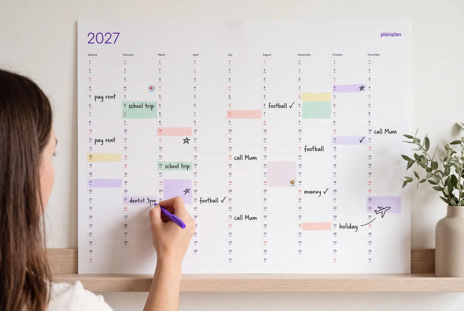 Hand writing on a plainplan 2027 wall planner